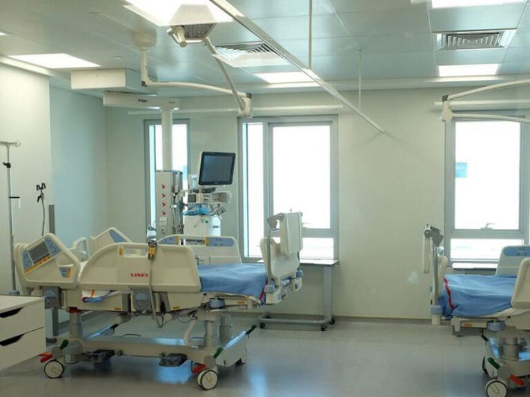 Hospital room with medical beds and healthcare monitoring equipment used for patient treatment